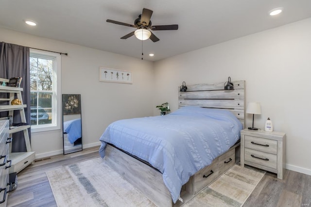 bedroom with light wood-type flooring and ceiling fan