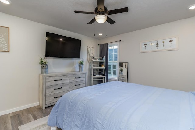 bedroom featuring ceiling fan and light hardwood / wood-style flooring