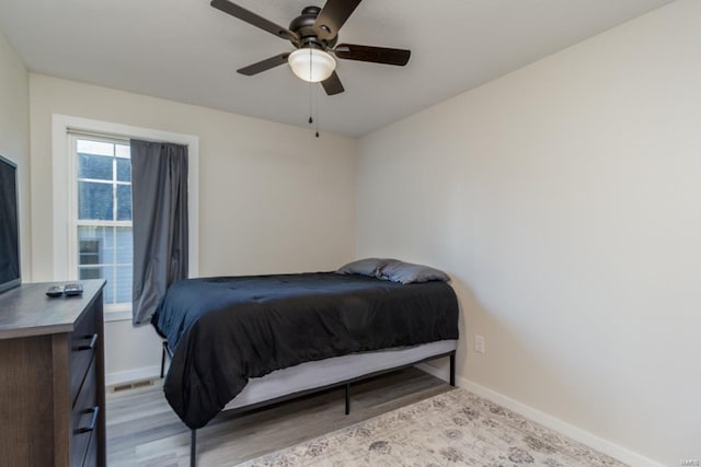 bedroom with light hardwood / wood-style floors and ceiling fan