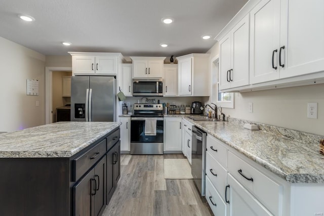 kitchen featuring sink, white cabinets, and appliances with stainless steel finishes