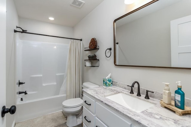 full bathroom with vanity, shower / tub combo, and toilet