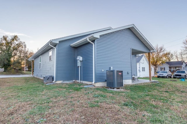 view of home's exterior featuring cooling unit, a yard, and a patio