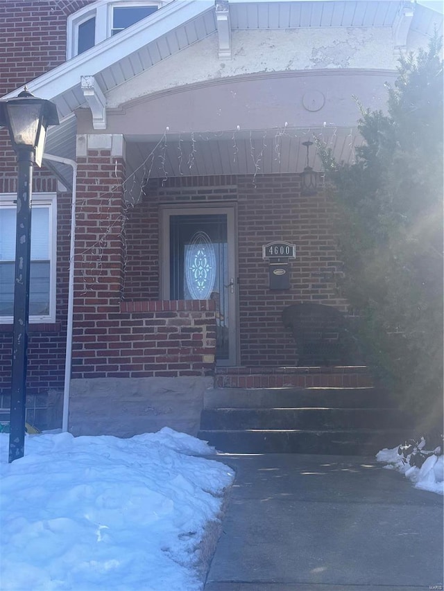 view of snow covered property entrance