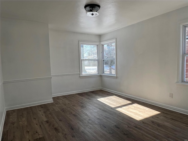 unfurnished room with dark hardwood / wood-style flooring