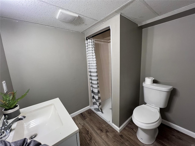 bathroom featuring hardwood / wood-style floors, a shower with curtain, a paneled ceiling, and toilet