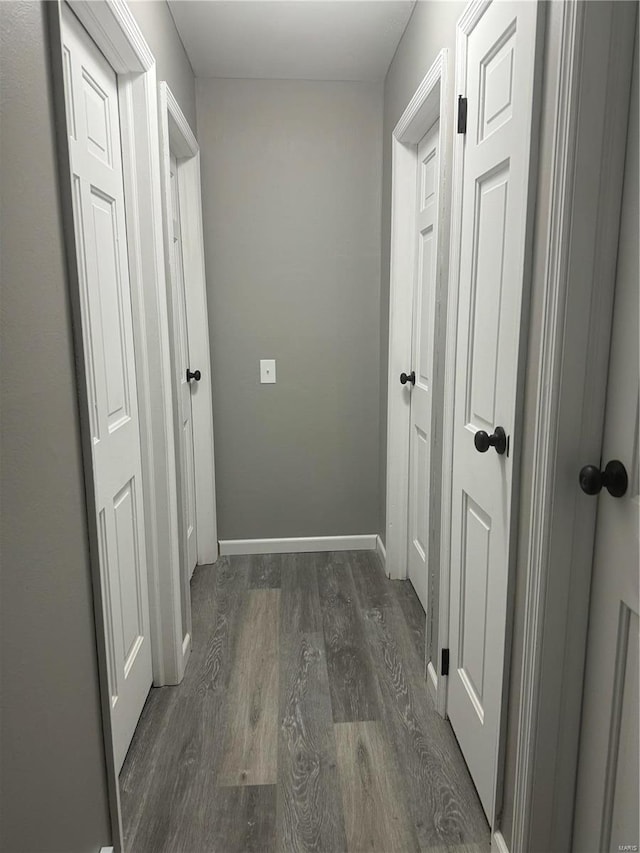 corridor with dark hardwood / wood-style floors