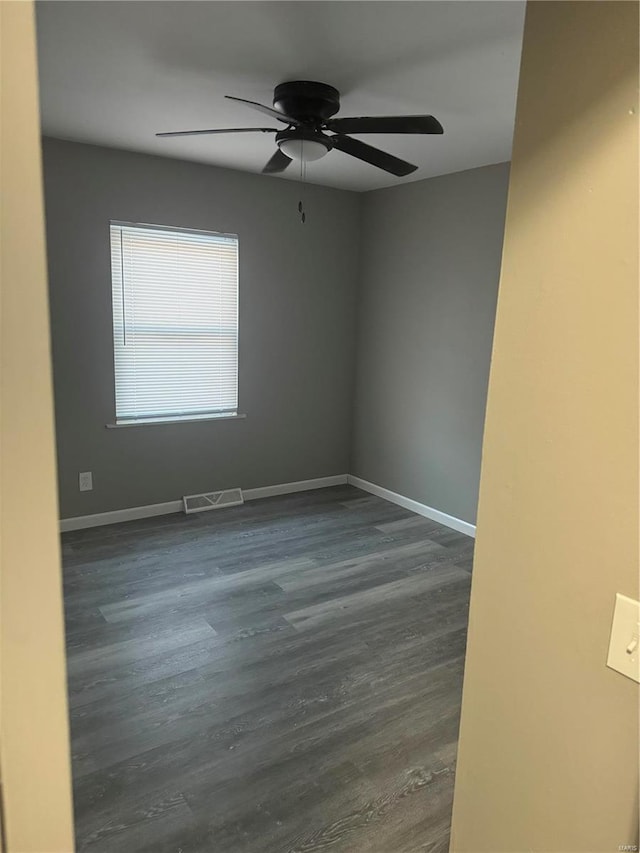 unfurnished room with ceiling fan and dark hardwood / wood-style floors