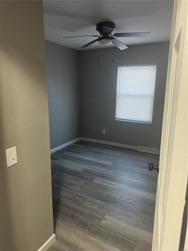 spare room featuring ceiling fan and dark hardwood / wood-style flooring