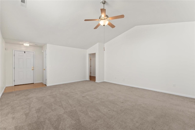 unfurnished living room featuring lofted ceiling, light colored carpet, and ceiling fan