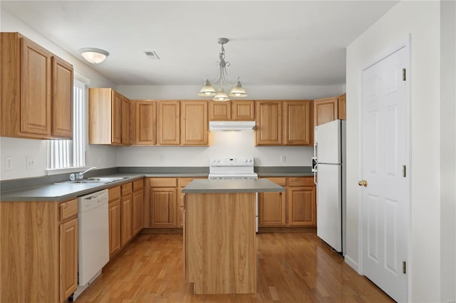 kitchen featuring a center island, light hardwood / wood-style flooring, white appliances, and decorative light fixtures