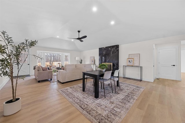 dining area featuring vaulted ceiling, ceiling fan, and light hardwood / wood-style floors