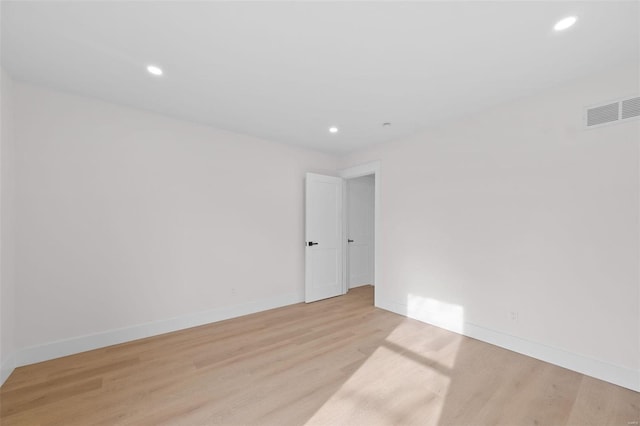 spare room featuring light hardwood / wood-style flooring