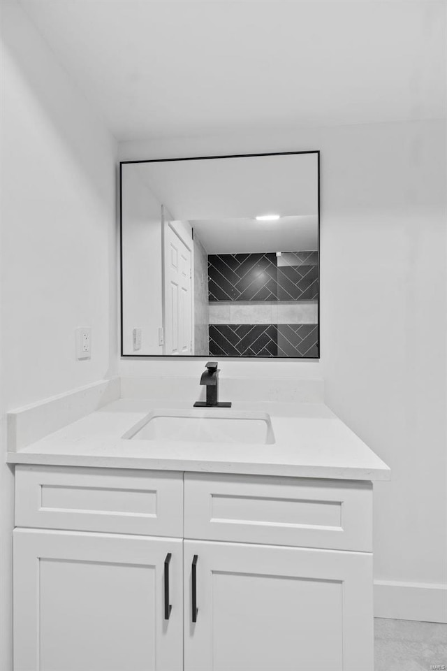 interior space with white cabinetry and sink