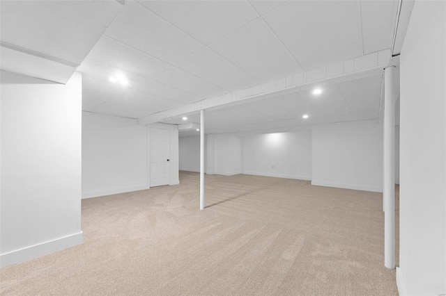 basement featuring light colored carpet