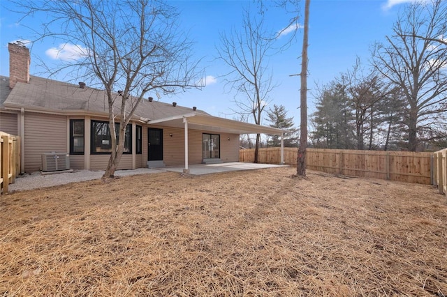 rear view of property with central AC and a patio