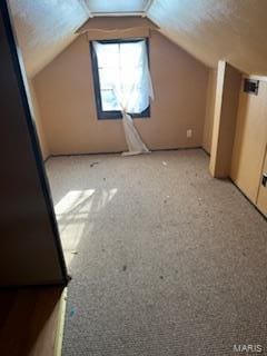 bonus room featuring light carpet and vaulted ceiling