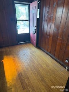 spare room with wooden walls and light hardwood / wood-style floors