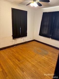 spare room featuring hardwood / wood-style flooring and ceiling fan