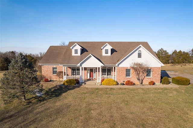 cape cod home featuring a porch and a front yard