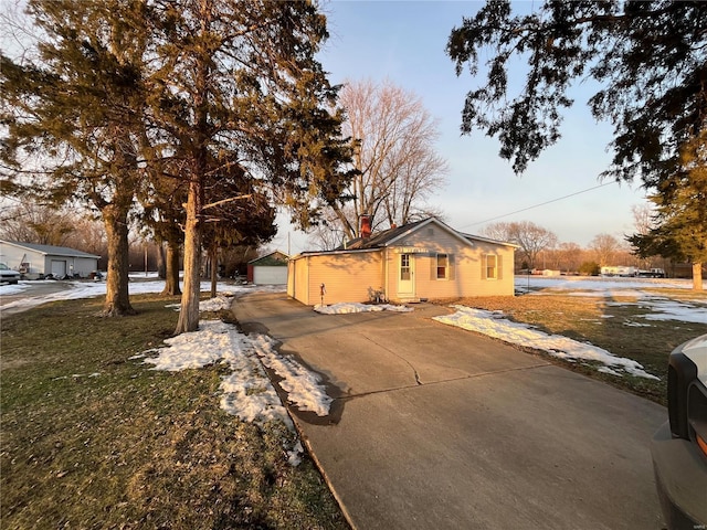 view of front facade featuring an outbuilding, a garage, and a front lawn