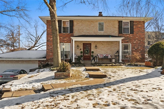 view of property featuring a porch and a garage