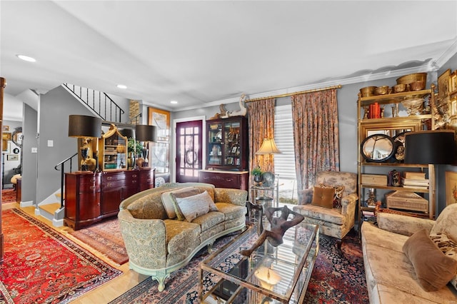 living room with crown molding and wood-type flooring