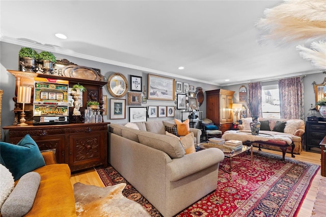 living room with ornamental molding and light hardwood / wood-style floors