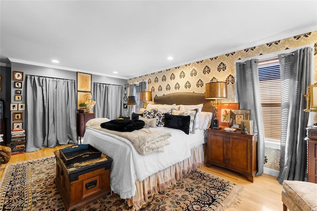 bedroom featuring crown molding and light hardwood / wood-style floors