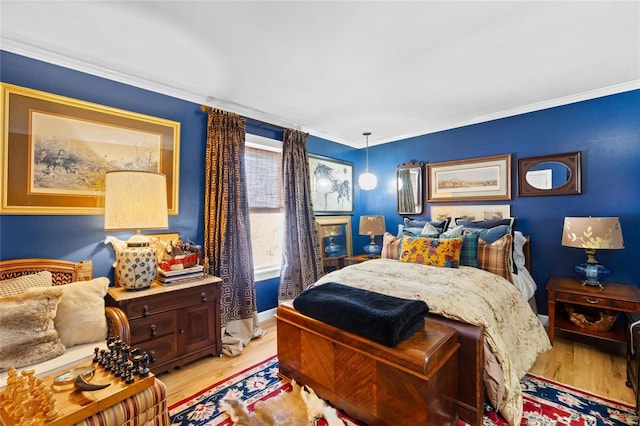 bedroom with crown molding and light hardwood / wood-style flooring