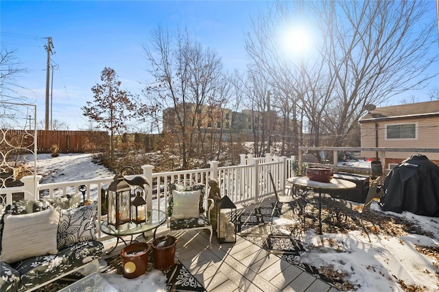 snow covered deck with grilling area