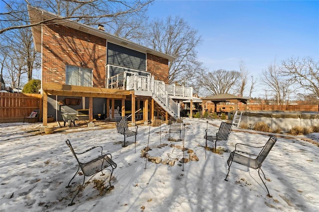 snow covered property with a deck