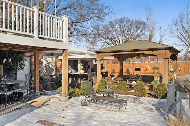 snow covered patio featuring a gazebo