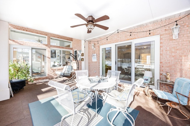 sunroom with a wealth of natural light and ceiling fan