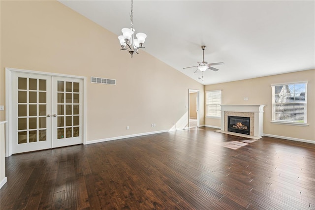 unfurnished living room with french doors, high vaulted ceiling, dark hardwood / wood-style floors, and ceiling fan with notable chandelier