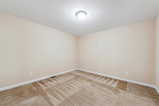 unfurnished room featuring carpet