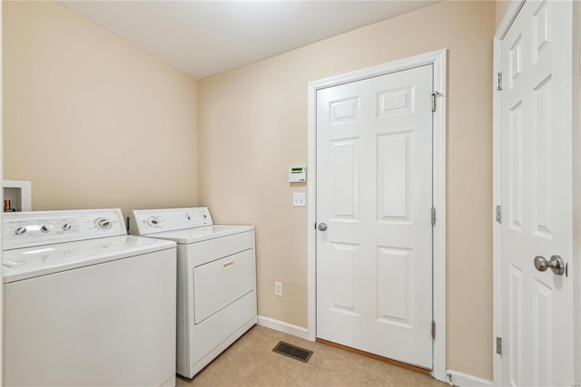 clothes washing area with washer and dryer