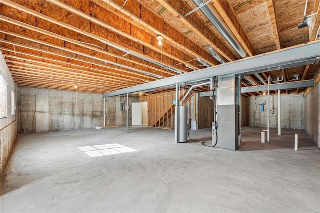 basement featuring water heater and heating unit