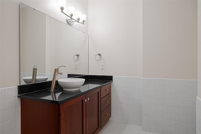 bathroom featuring vanity, tile patterned flooring, and tile walls