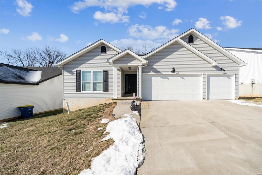 view of front of property with a garage and a front lawn