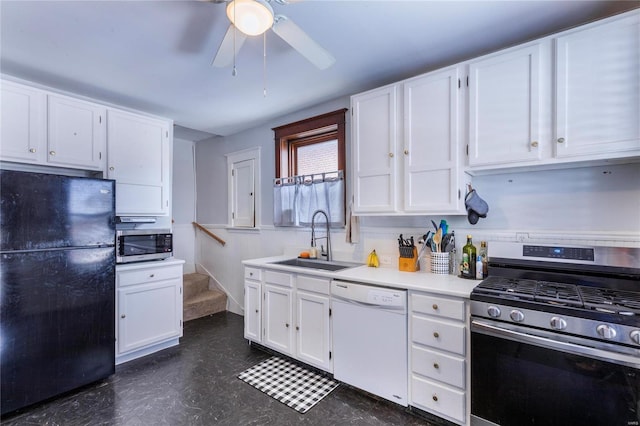 kitchen with stainless steel appliances, white cabinetry, sink, and ceiling fan