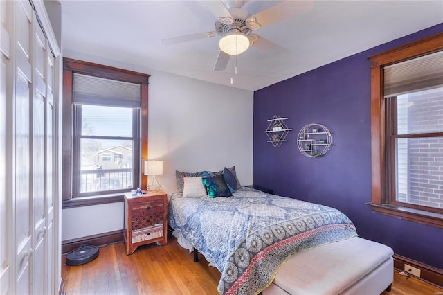 bedroom featuring multiple windows, ceiling fan, and a closet