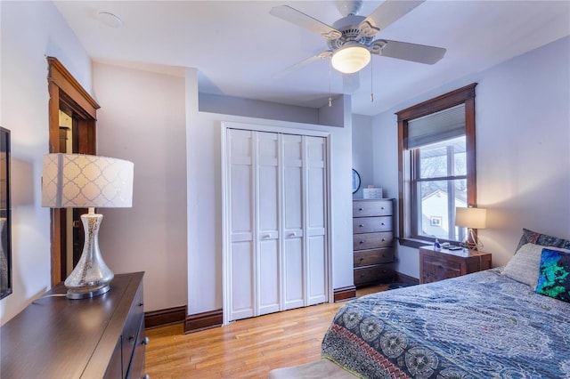 bedroom featuring light hardwood / wood-style flooring, a closet, and ceiling fan