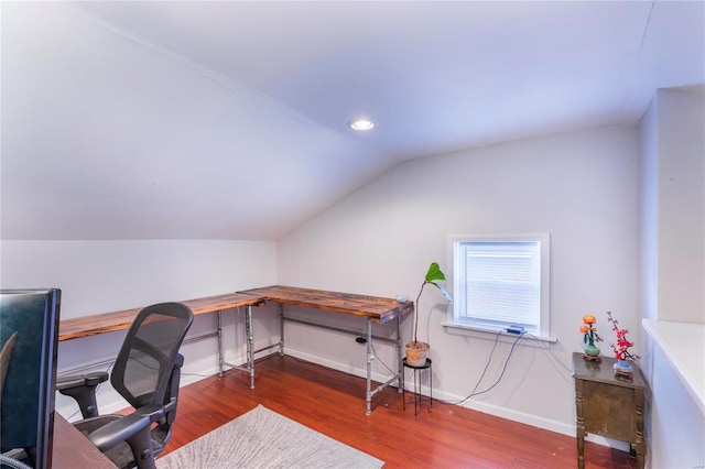 office area featuring dark wood-type flooring and vaulted ceiling