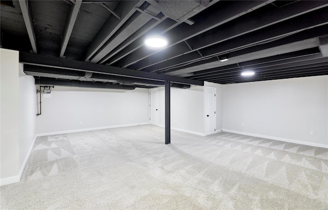 basement featuring light colored carpet