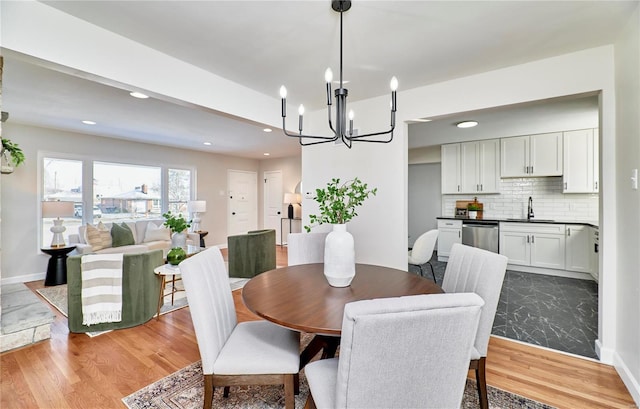 dining space featuring sink and light wood-type flooring