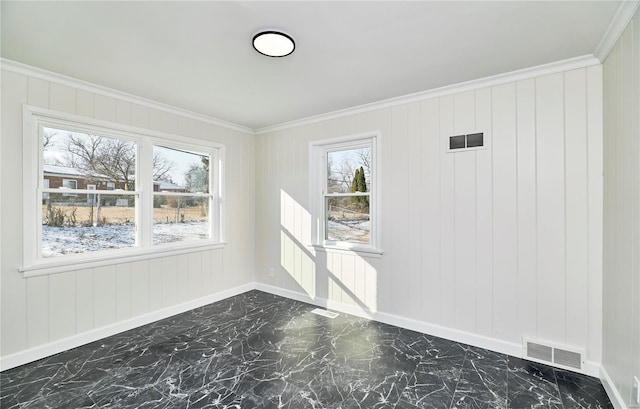 empty room featuring crown molding