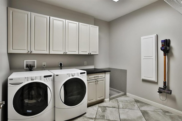 laundry area with cabinets and washer and dryer