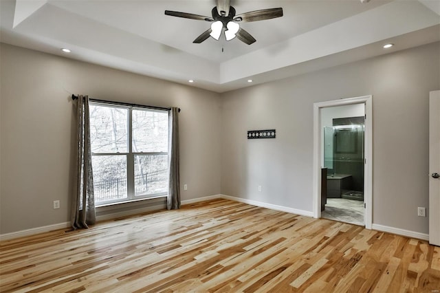 spare room with ceiling fan and light wood-type flooring