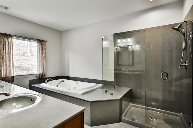 bathroom featuring vanity and separate shower and tub