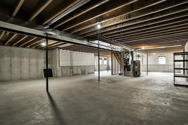 basement featuring heating unit and water heater